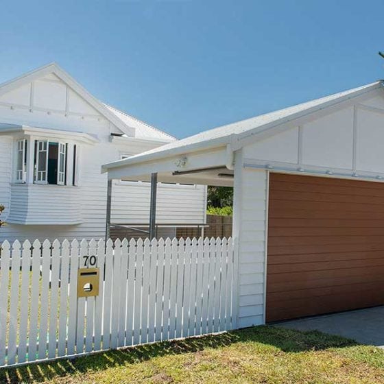 amazing builds front of heritage house with carport